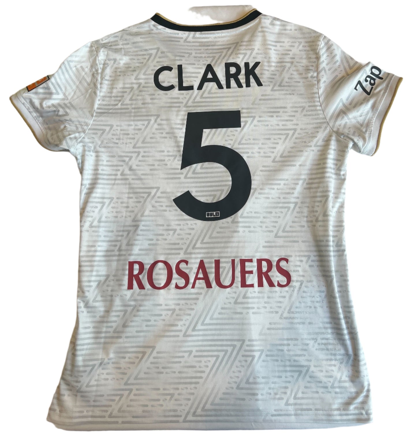White sports jersey with 'Clark 5' and 'Rosauers' text on a white surface.