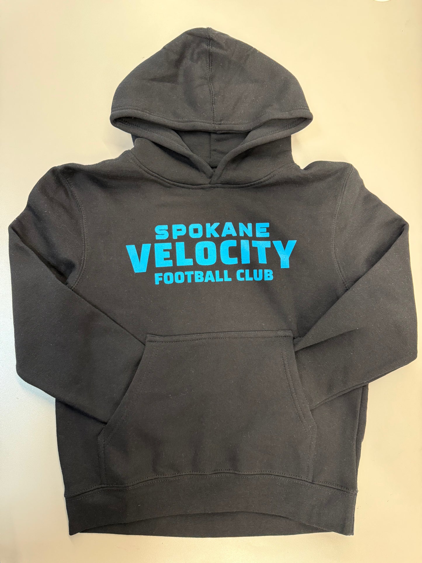 Black hoodie with blue 'Spokane Velocity Football Club' text on a white background