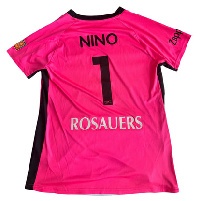 Pink sports jersey with 'NINO' and number '1' on a white surface