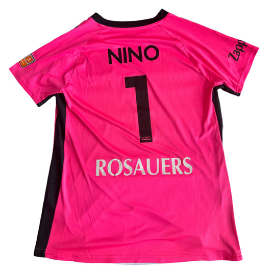 Pink sports jersey with 'NINO' and number '1' on a white surface