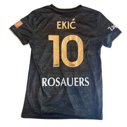 Black sports jersey with gold lettering on a white surface