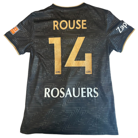Black sports jersey with gold and white text on a white surface