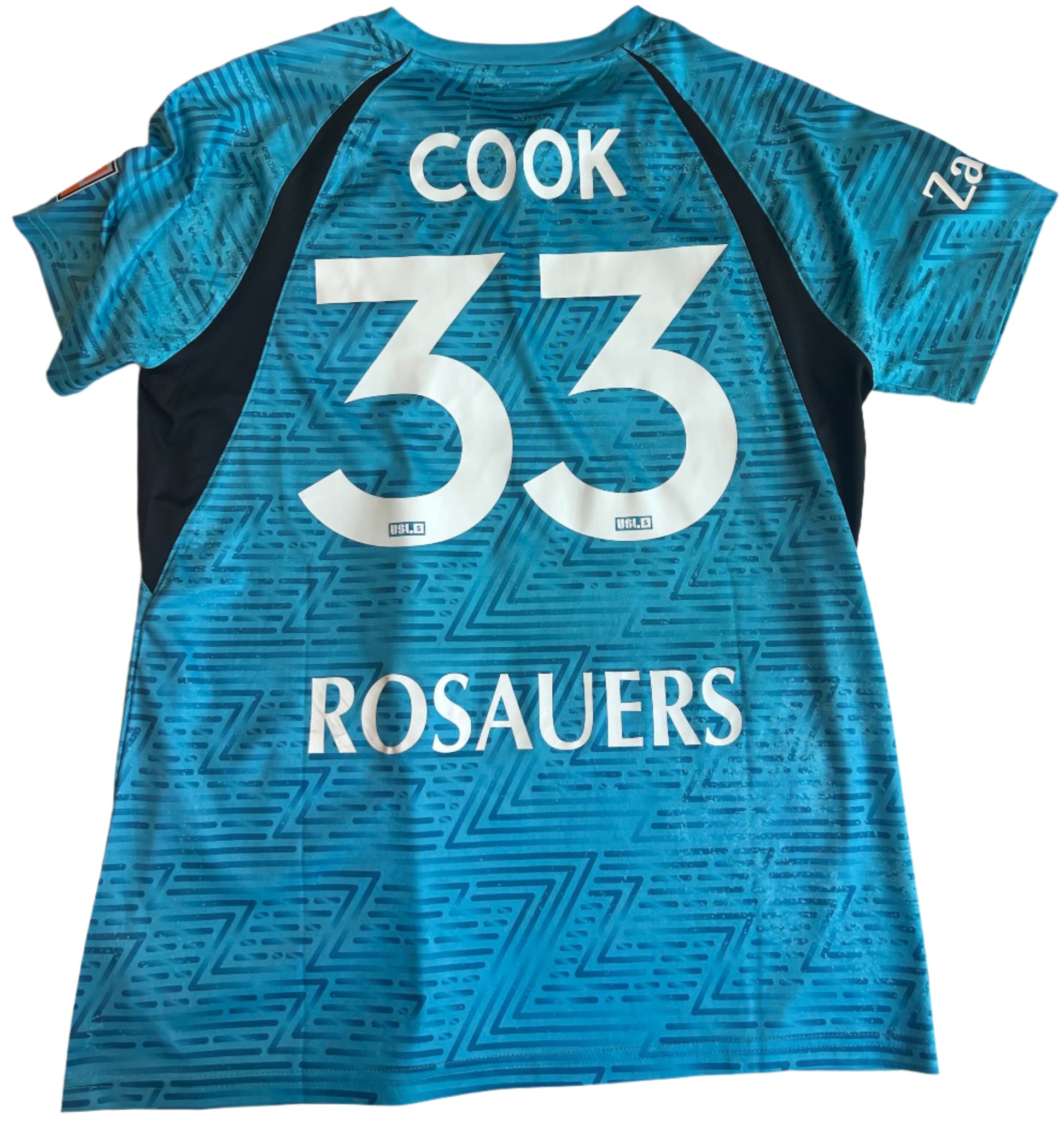 Blue sports jersey with 'Cook 33 Rosauers' printed on a white surface