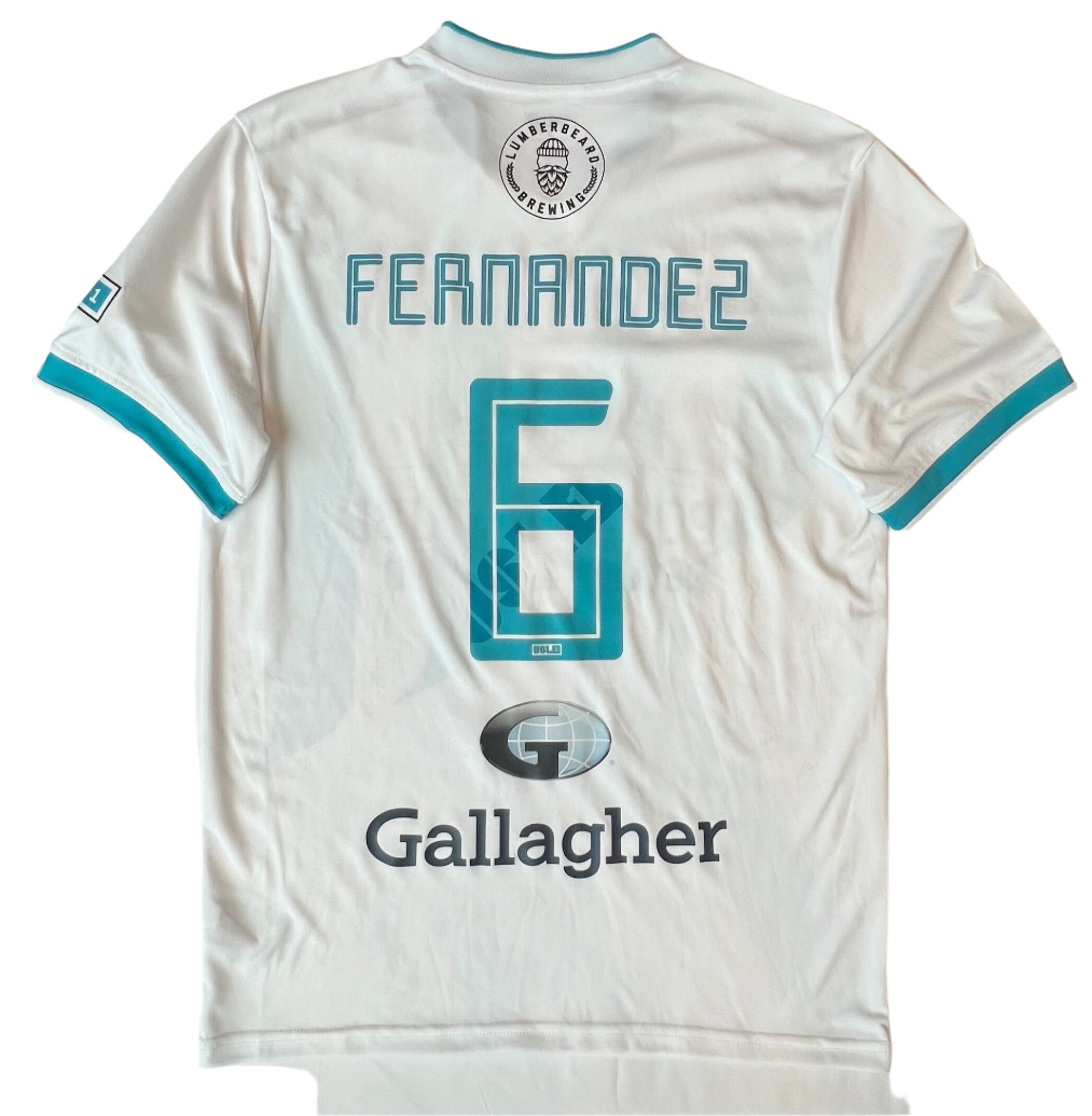 White sports jersey with 'Fernandez 6' printed on it, displayed on a table.